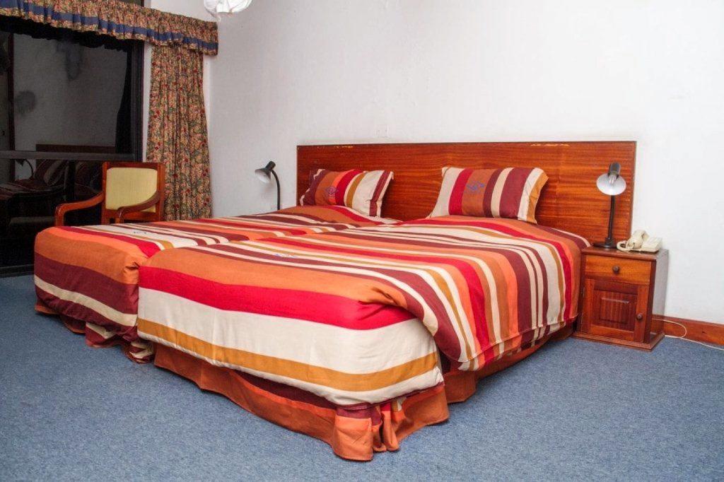 Twin bed in one of the rooms at Margherita Hotel in Kasese
